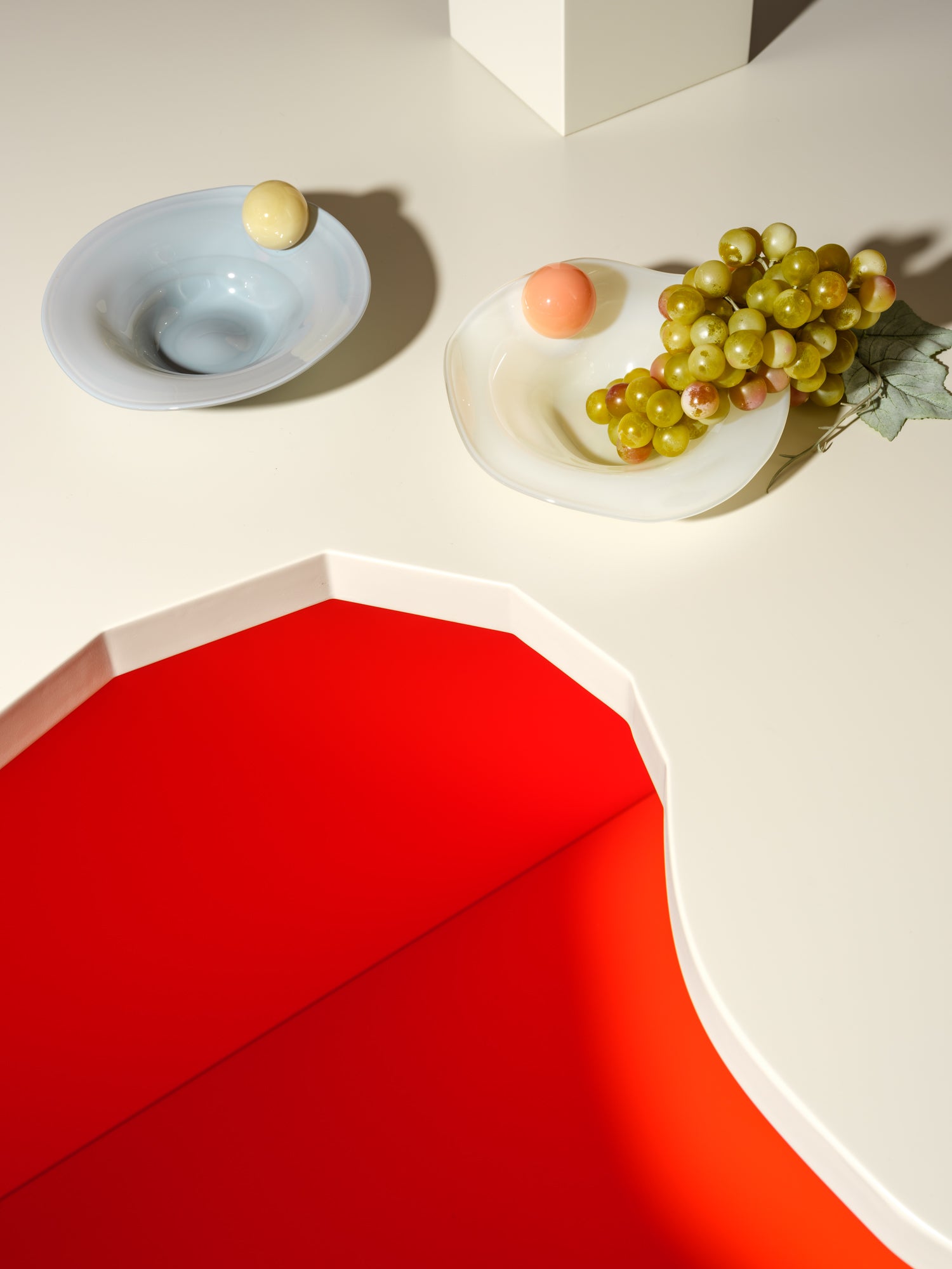 two breakfast bowls with a ball on the side in yellow, blue, orange and white